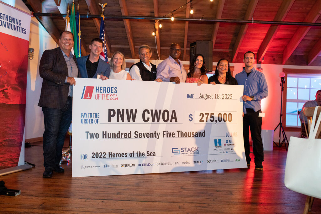 STACK Americas CCO presents check to the Pacific Northwest CWOA of the U.S. Coast Guard.